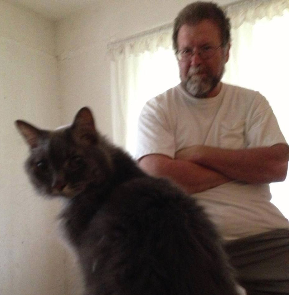 
                      Buddy the cat looking at you and Frank sitting behind Buddy
                    